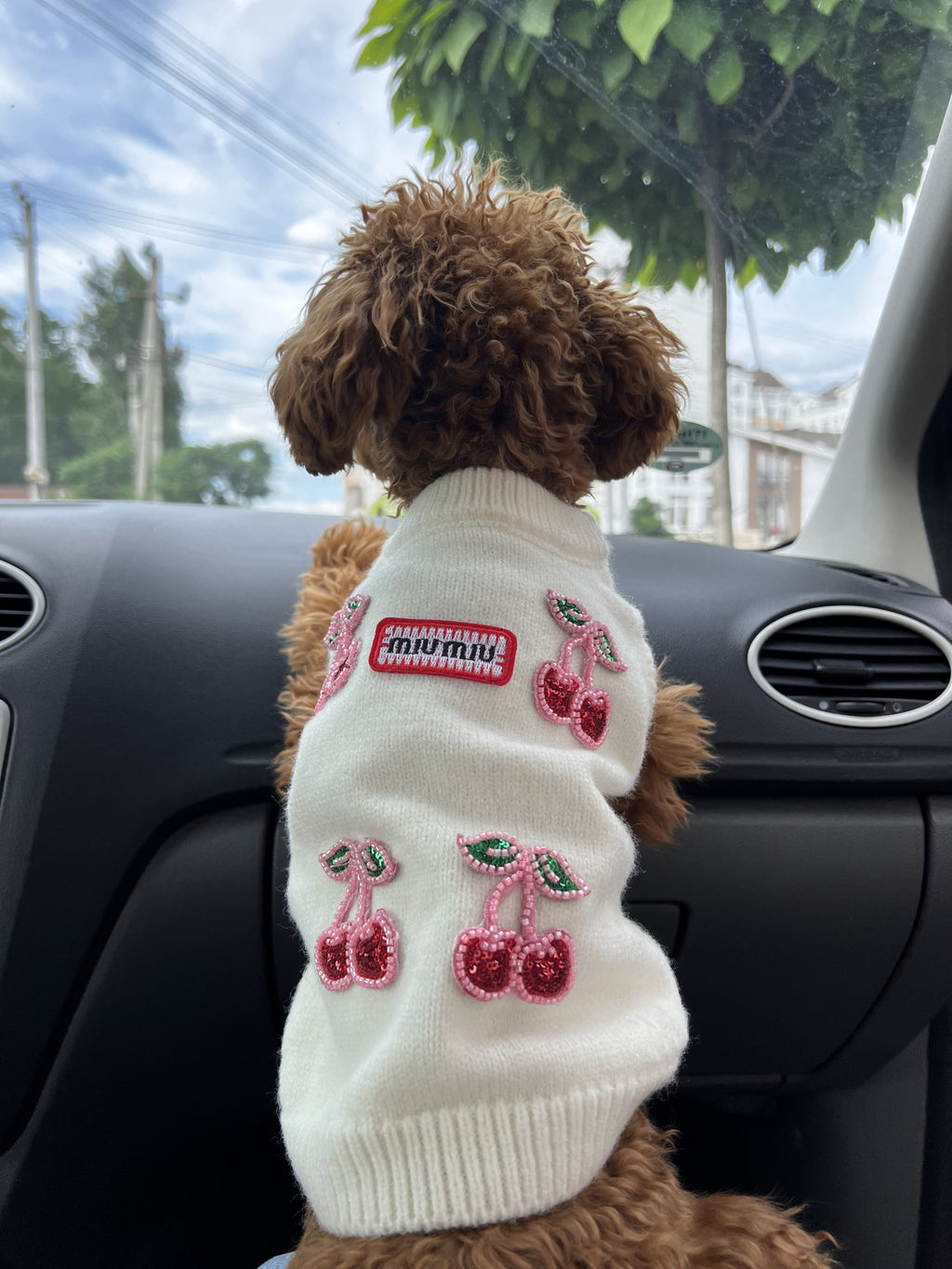 Milk-colored sleeveless sweater with Miu Miu print