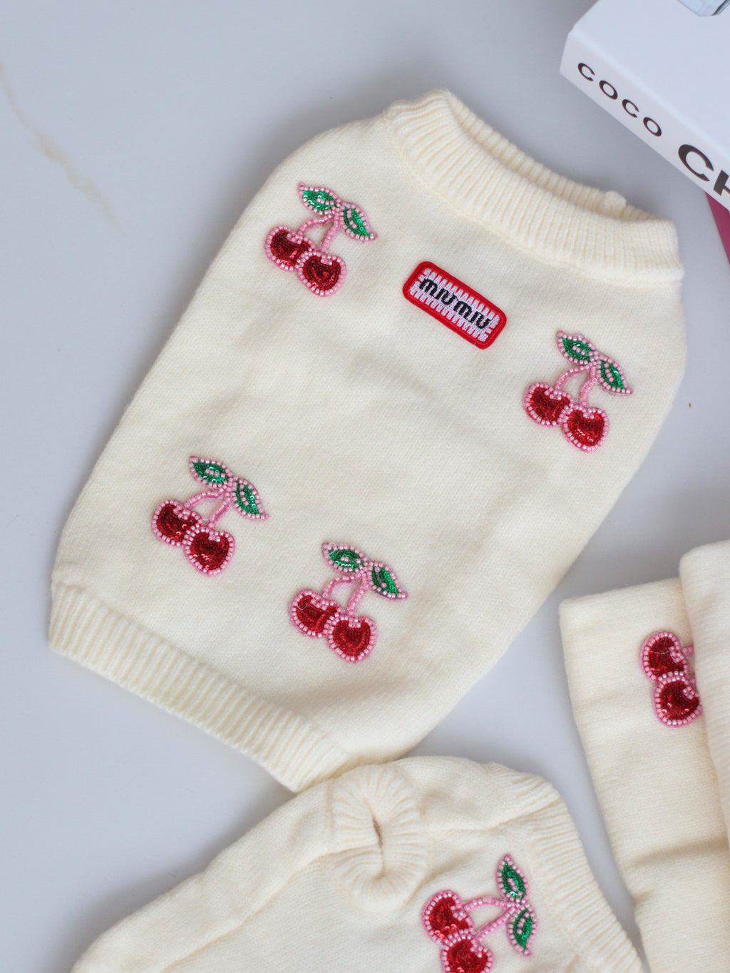 Milk-colored sleeveless sweater with Miu Miu print